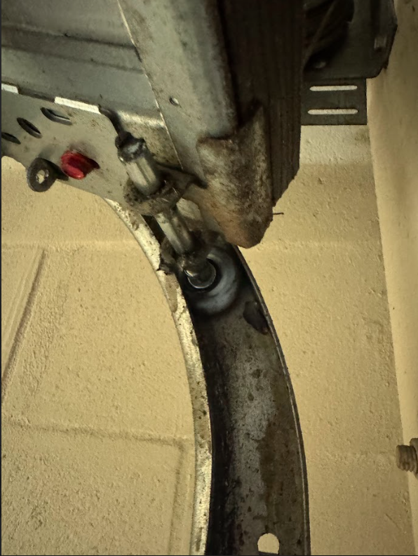 Close-up of worn garage door spring and hardware inspected by Revive Garage Doors